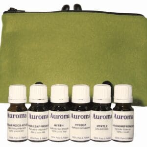 Six essential oil bottles labeled Auroma with a green pouch in the background.