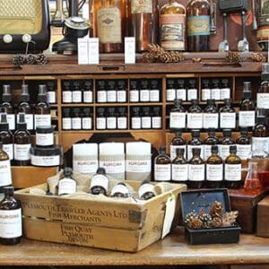 Shelves displaying various jars, bottles, and containers in a rustic shop.