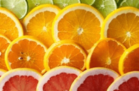 Close-up of sliced citrus fruits including oranges and grapefruit.